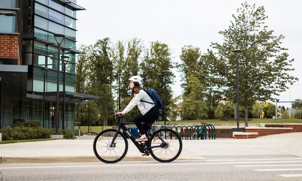 man in white shirt riding bicycle on road during daytime