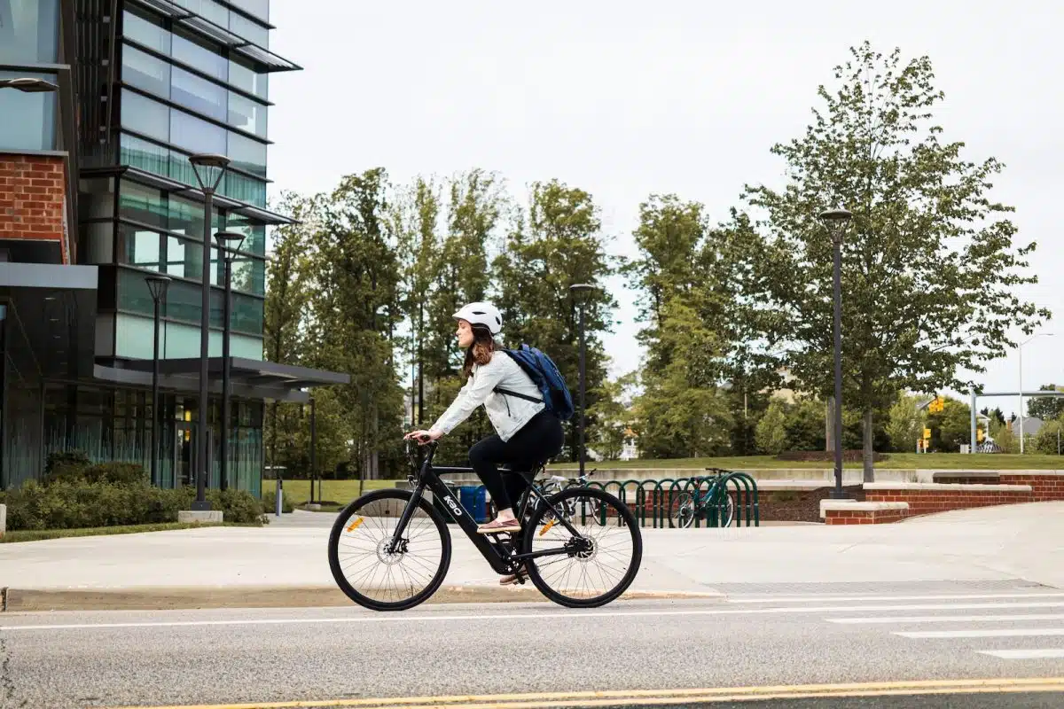 man in white shirt riding bicycle on road during daytime
