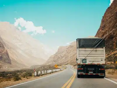 white and black truck near mountain at daytime